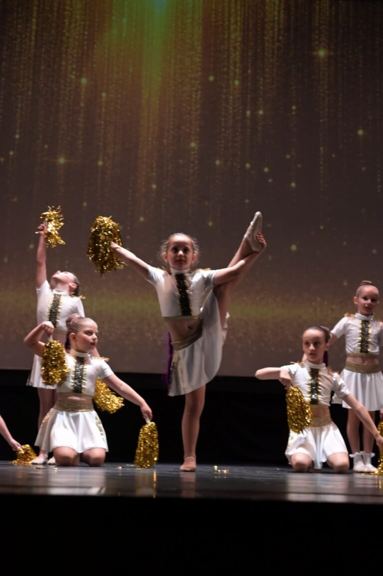Παιδιά με χρυσά pom-poms σε χορογραφία μοντέρνου χορού